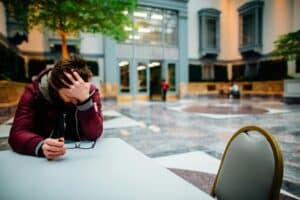 man at table being depressed