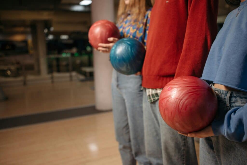 people bowling with others