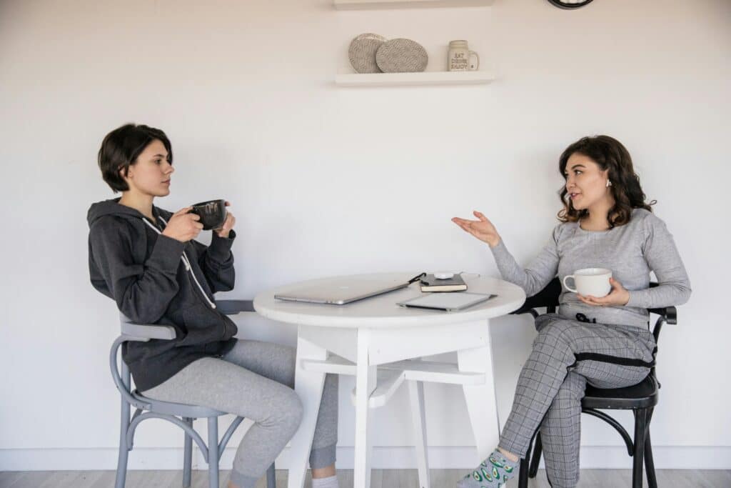 two women talking over coffee