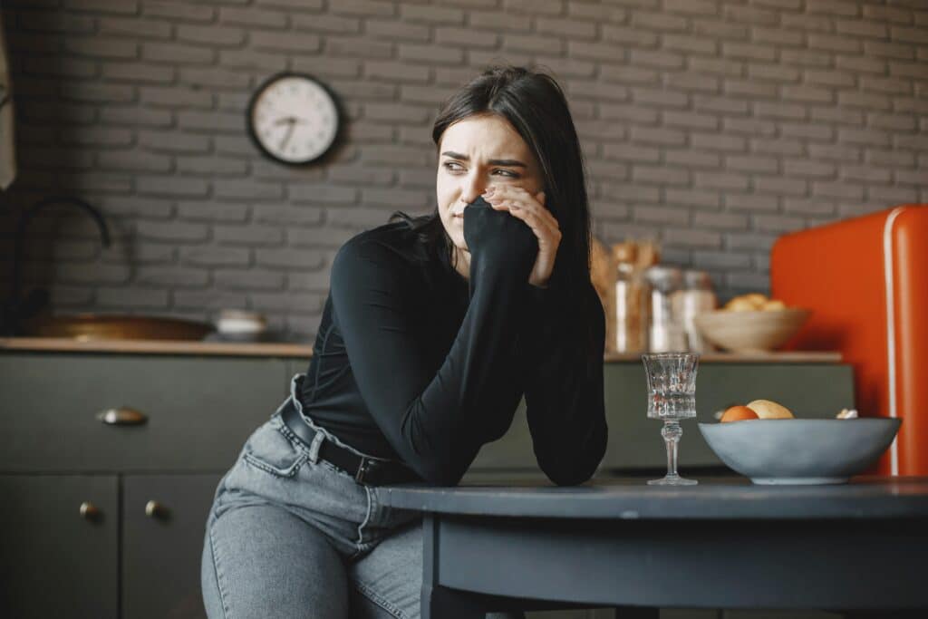 woman in kitchen thinking