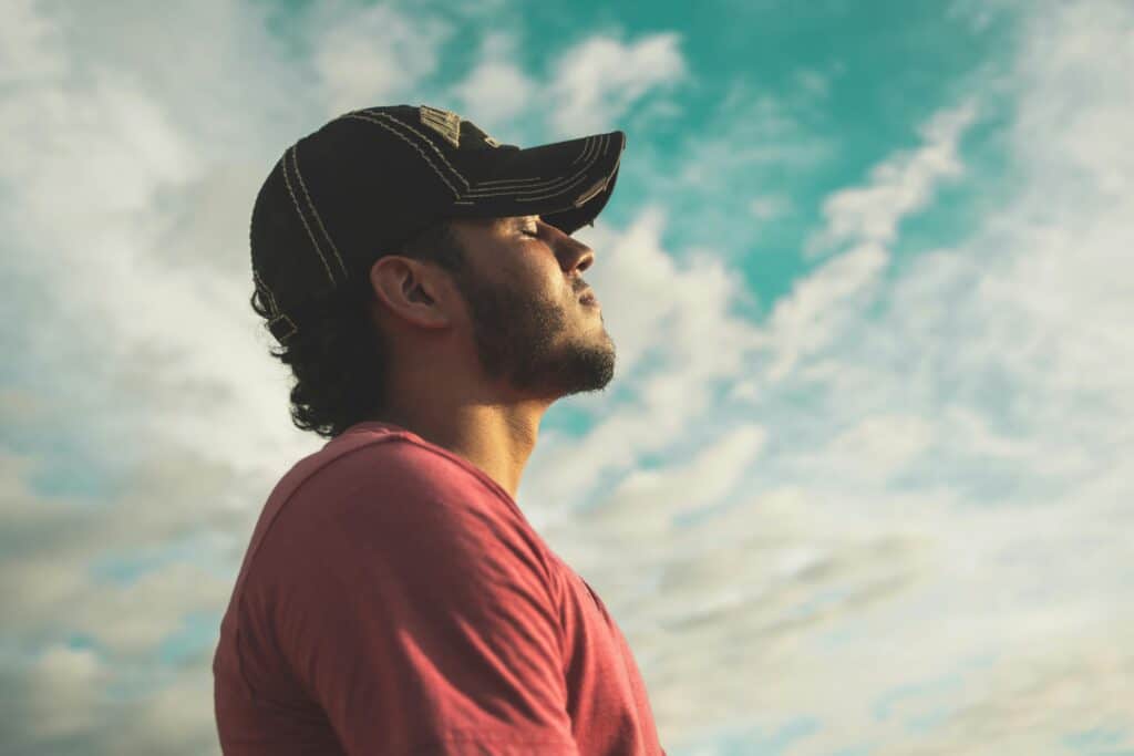 man breathing outside on a sunny day