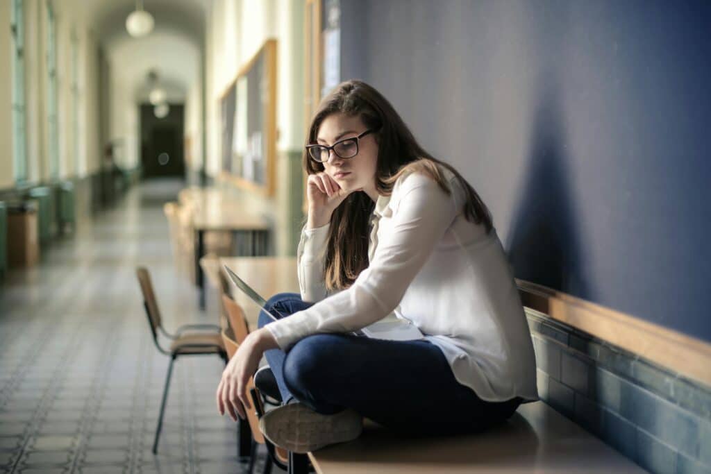 woman in hallway being sad