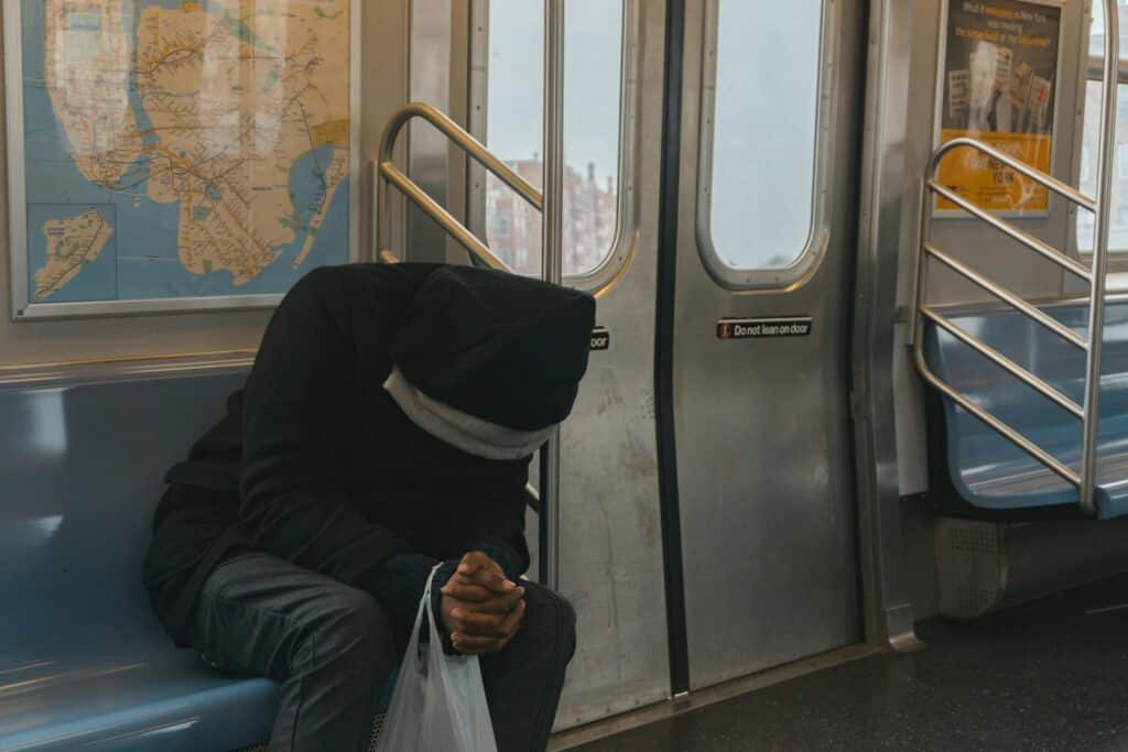 man sitting on train stressing