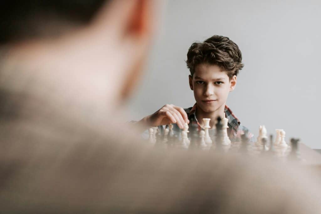 young boy playing chess