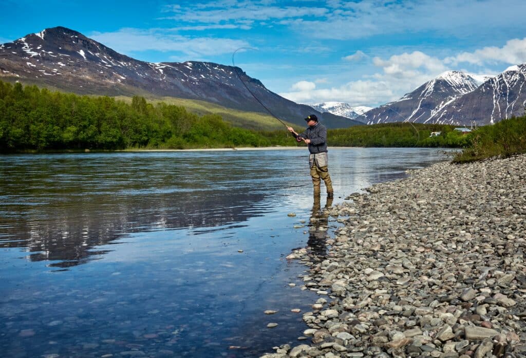 man fishing off shore