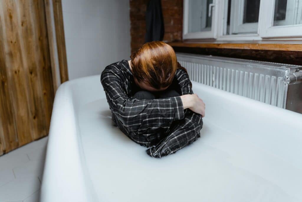 person sitting in bathtub