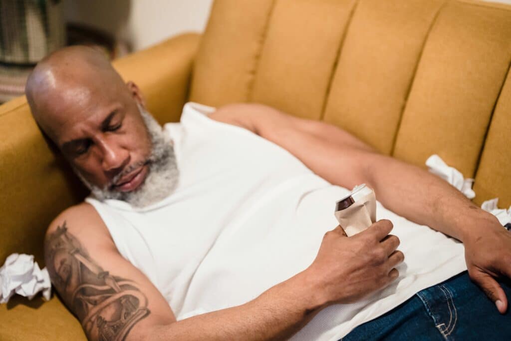 man falling asleep on the couch