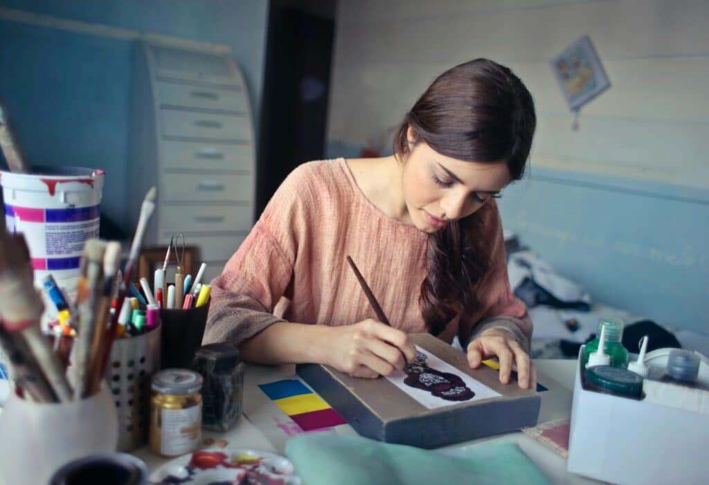 person being creative and painting