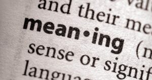 Close-up of a printed page showing the bold word 'meaning' with surrounding text visible.