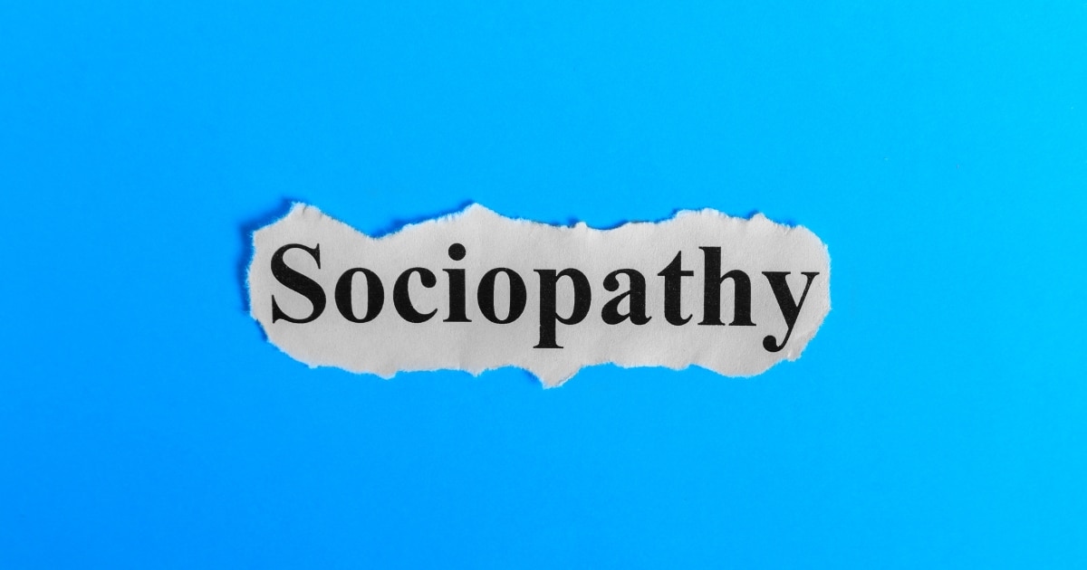 Torn piece of paper with the word 'Sociopathy' on a bright blue background.