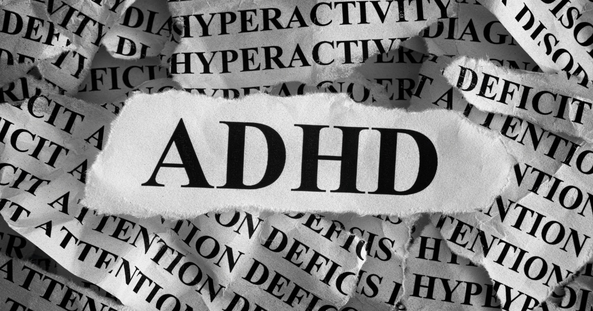 Torn strips of paper with the word ADHD repeatedly, a white torn patch in the center displays 'ADHD'.